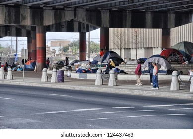NEW ORLEANS - MAR 24: Homeless people prepare to spend the night under a bridge, March 24, 2009 in New Orleans. 200 homeless live in the compound of tents and makeshift shelters.
