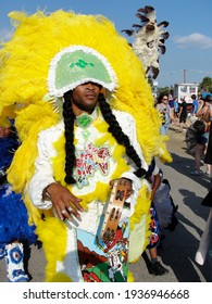 New Orleans - May 5, 2011:  Costumed Mardi Gras Indian With Tamborne Performs At Jazz Fest