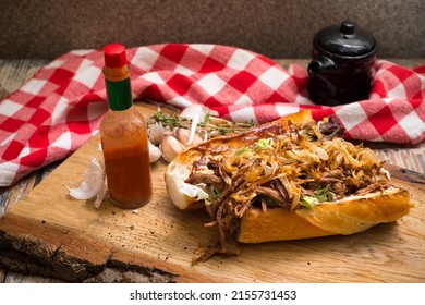 New Orleans Roast Beef Debris Po Boy sandwich. Slow Cooked Roast Beef stew filling, fried onion chips and a hot sauce.