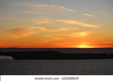 New Orleans Skyline As Sunsets On The Horizon. Picture Taken From The North Shore Of Lake Pontchartrain In Slidell, Louisiana.