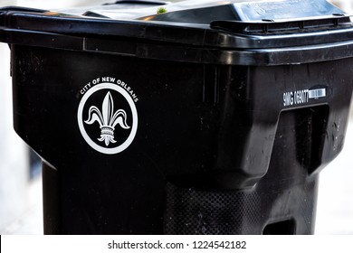 New Orleans, USA - April 22, 2018: Exterior city trash can in Louisiana, fleur-de-lis sign, rubbish garbage bin