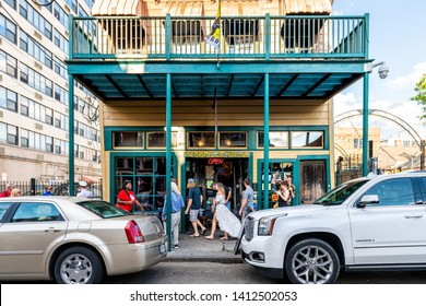 New Orleans, USA - April 22, 2018: Frenchmen Street In Louisiana Town Old Building Entrance To Famous Spotted Cat Music Club And People Walking