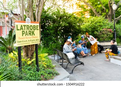 New Orleans, USA - April 22, 2018: People, Women Sitting On Benches At LaTrobe Green City Park With Water Fountain In Louisiana Old Town