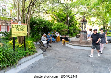 New Orleans, USA - April 22, 2018: People Walking, Women Sitting On Benches At LaTrobe Green City Park With Water Fountain In Louisiana Old Town