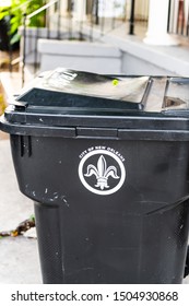 New Orleans, USA - April 22, 2018: Closeup of outdoor city trash can or rubbish garbage bin in Louisiana city with fleur-de-lis sign symbol