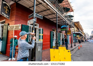 New Orleans, USA - April 23, 2018: Old Town Bourbon Street Intersection Sign In Louisiana Famous Town City And Tourist Man Taking Picture Photo With Phone