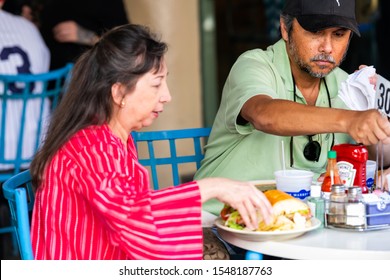 New Orleans, USA - April 23, 2018: People Couple Sitting Eating Cajun Creole Cuisine Food At The Market Cafe Restaurant Tables