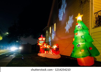 New Orleans, USA - Dec 1, 2017: Side of a Southern style American house along Fleur De Lis Drive. Night scene with lit up Christmas decorations by the side of the house.
