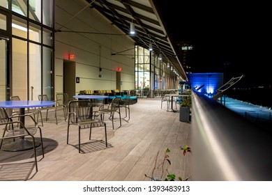 New Orleans, USA - Dec 10, 2017: Night View At The Public Seating Area And Lounge Observation Deck Behind The Outlet Collection Shopping Mall Precinct. No One Around Due To The Increasing Cold.