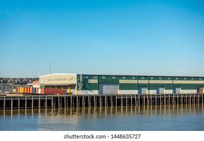 New Orleans, USA - Dec 11, 2017: The Governor Nicholl's Street Wharf As Seen From The Mississippi River. Some Shipping Containers Are In The Front Of The Building.