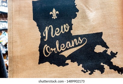 New Orleans, USA - Dec 11, 2017: Jute bag hanging from a souvenir shop. The textured surface is imprinted with a diagram of the State of Louisiana, complete with Fleur-de-lis logo and text.