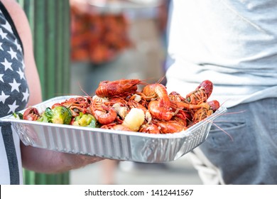 New Orleans, USA Louisiana Town With People By Restaurant Eating Seafood Lobsters Holding Trays