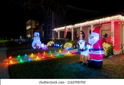 New Orleans, USA - Nov 27, 2017: Southern Style American House Along Fleur De Lis Drive, With Lit Up Entrance. Night Scene With Santa Claus, Reindeer And Christmas Lights At The Front Of The House.