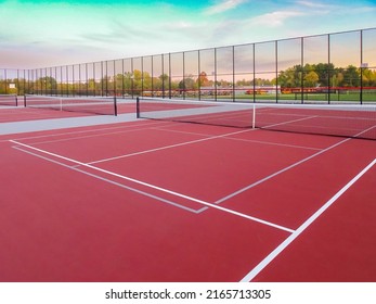 New outdoor red tennis courts with white lines and gray pickleball lines.	