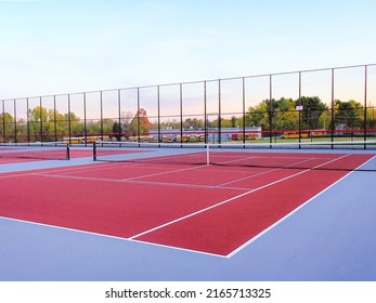 New outdoor red tennis courts with white lines and gray pickleball lines.	 - Powered by Shutterstock