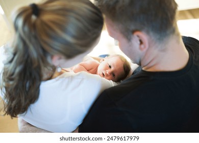 New parents holding newborn baby girl. Unconditional paternal love, idyllic family moment. - Powered by Shutterstock