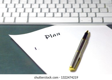 New planning Concept (sequence of items written by pen on white sheet of paper), on wooden table with green leather cover. White modern keyboard on background. Close up, copy space.