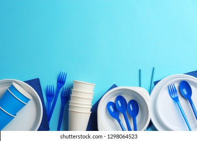 New plastic dishware and space for text on color background. Table setting