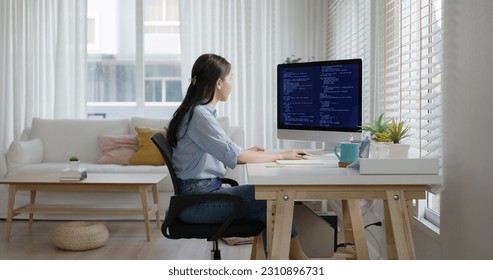 New possible digital transformation workforce. Asia young woman happy work at home office self cheering success reskill upskill job done remote test on desktop AI design online and cyber security.