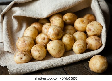 new potatoes with the peel on the table in a bag, food close up - Shutterstock ID 146653856