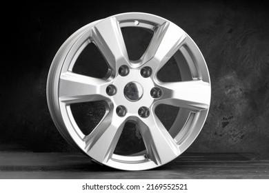 a new powerful six-spoke alloy wheel in silver color on a dark textured background. auto parts for SUVs and crossovers.