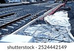 new and precise laying of tracks using leveling devices at the fork in two tram tracks. a layer of gravel above which concrete sleepers are placed. rubber anti-vibration base made of rubber