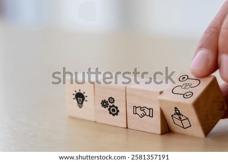New product development and project roadmap concept. Wooden blocks with the stages of new product development icons, ideation, development and launching. 