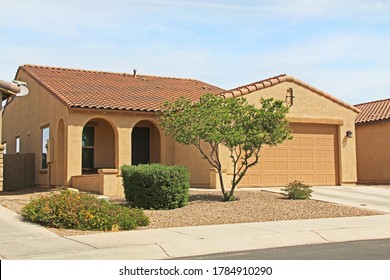 New Ranch, Gold And Mustard Yellow Stucco Home In Tucson, Arizona, USA With Beautiful Blue Sky And Landscaping.