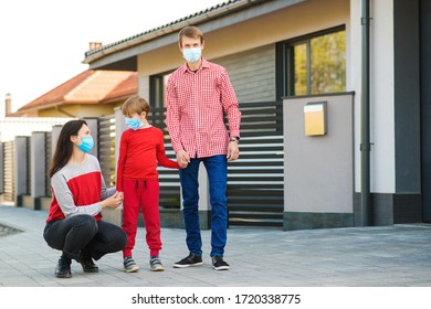 New Real Life. Fight Coronavirus. Young Family Wearing Face Mask Outdoors. Safety Mask To Protect Coronavirus Outbreak. Prevention Coronavirus. Son With Parents Going For A Walk.