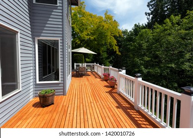 New red cedar outdoor wooden deck during nice weather in horizontal layout   - Shutterstock ID 1420010726