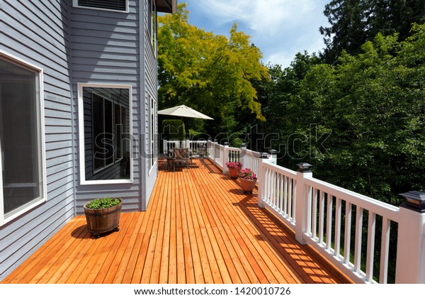 New red cedar outdoor wooden deck during nice\
weather in horizontal layout \
