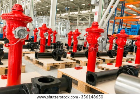 New red fire hydrant on plant`s warehouse