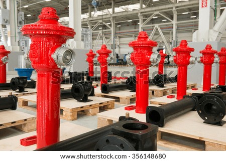 New red fire hydrant on plant`s warehouse