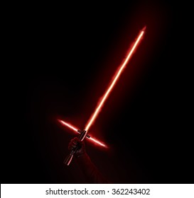 New red light saber holdng in hand isolated on black. Lightsaber futuristic movie weapon. Sabre sword with fire force. Beam weapon equipment. Laser steel swords. Dark and light force.