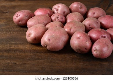 New red potatoes on wood