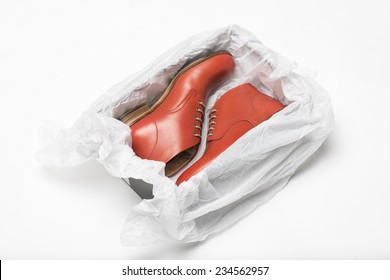 new red shoes in box with wrapping paper