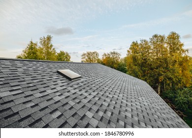 new renovated roof covered with shingles flat polymeric roof-tiles