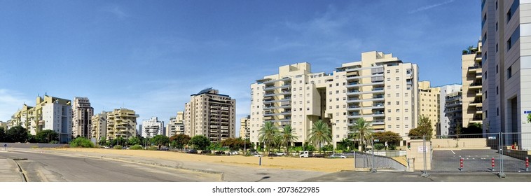 New residential area with modern houses and a large landscaping of the territory of the city of Holon in Israel. View from the sand dune.