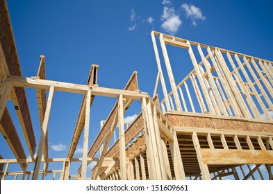 New residential construction home framing against blue sky