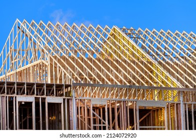 New residential construction home framing against a blue sky roofing construction wood sky trusses