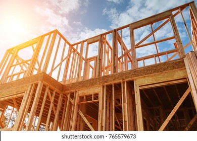 New residential construction home framing against a blue sky. Roofing construction. Wooden construction - Shutterstock ID 765579673