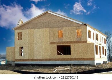 New Residential Frame House Under Construction Against A Blue Sky Plywood Windows Trimber