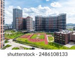 A new residential neighborhood with high-rise buildings, underground parking, a green recreation area and sports grounds in the Russian capital Moscow from a bird