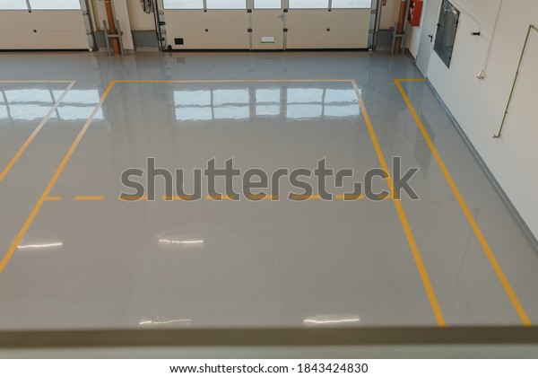 New  resin floor coating and marking signs in a\
car workshop.