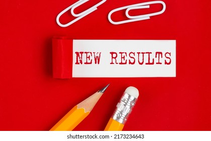 NEW RESULTS message written under torn red paper with pencils and clips, business - Shutterstock ID 2173234643