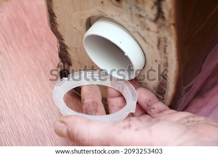 New ring big down nut mounting on drain fittings in the old ceramic brown toilet tank close up, DIY WC repair at home