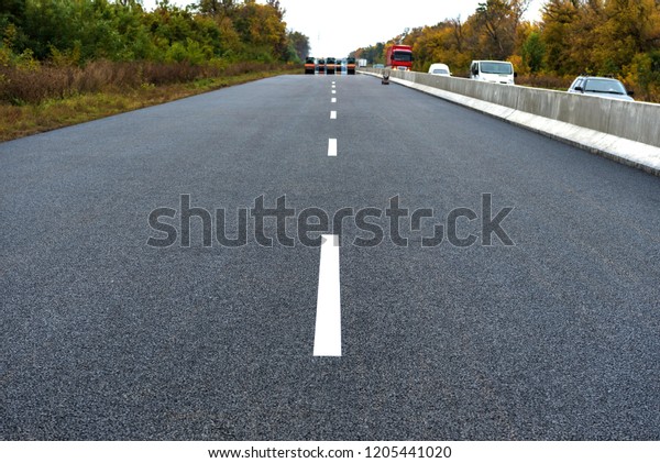 A new road with a dividing strip New\
Jersey. Road construction.