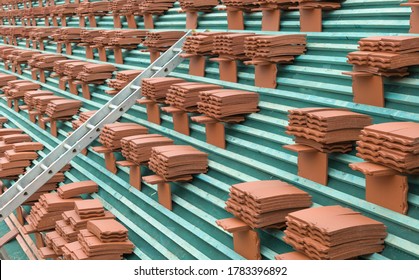 New Roof Tiles Stacked On A Roof Ready For Laying On A House According To Building Regulations, UK