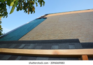 New roofing construction and asphalt shingles installation. A close-up of asphalt shingles installation on plywood, osb roof sheathing and waterproofing roof underlayment. - Shutterstock ID 2096069083