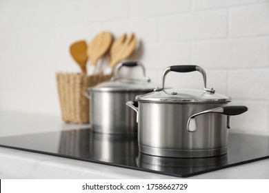 New saucepots on induction stove in kitchen - Shutterstock ID 1758662729
